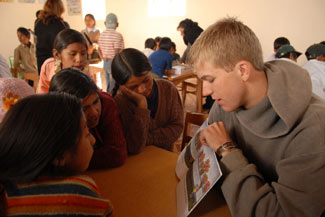 Volunteer, Chris Lauer, reading to kids in the Presto library.