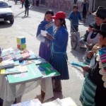Adults reading pamphlets about the importance of education
